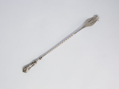 Antique sterling silver pickle fork. Very dainty and delicate looking sterling silver pickle fork in Queens Pattern. Lovely twist detail to the middle of handle finished with a decorative handle. Fully hallmarked to back of one of the fork tines for Birmingham assay c1897 and made by William Devenport. Fine quality piece. Main photo showing fork laid diagonally across the page with prong end in top right corner.