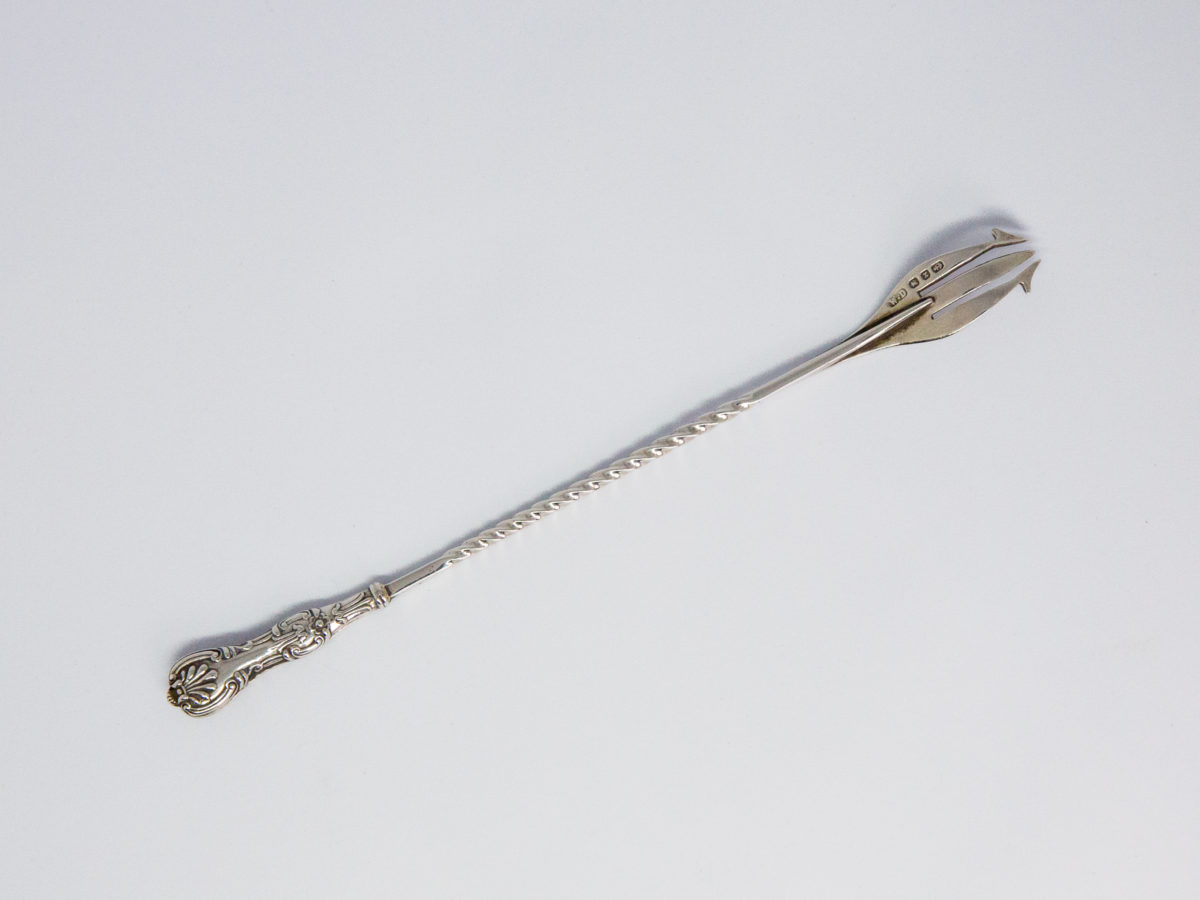 Antique sterling silver pickle fork. Very dainty and delicate looking sterling silver pickle fork in Queens Pattern. Lovely twist detail to the middle of handle finished with a decorative handle. Fully hallmarked to back of one of the fork tines for Birmingham assay c1897 and made by William Devenport. Fine quality piece. Photo of back of fork with prongs in top right corner of shot.