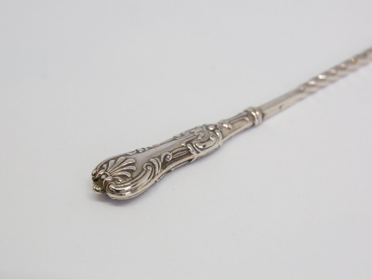 Antique sterling silver pickle fork. Very dainty and delicate looking sterling silver pickle fork in Queens Pattern. Lovely twist detail to the middle of handle finished with a decorative handle. Fully hallmarked to back of one of the fork tines for Birmingham assay c1897 and made by William Devenport. Fine quality piece. Close up photo of the intricate handle end.