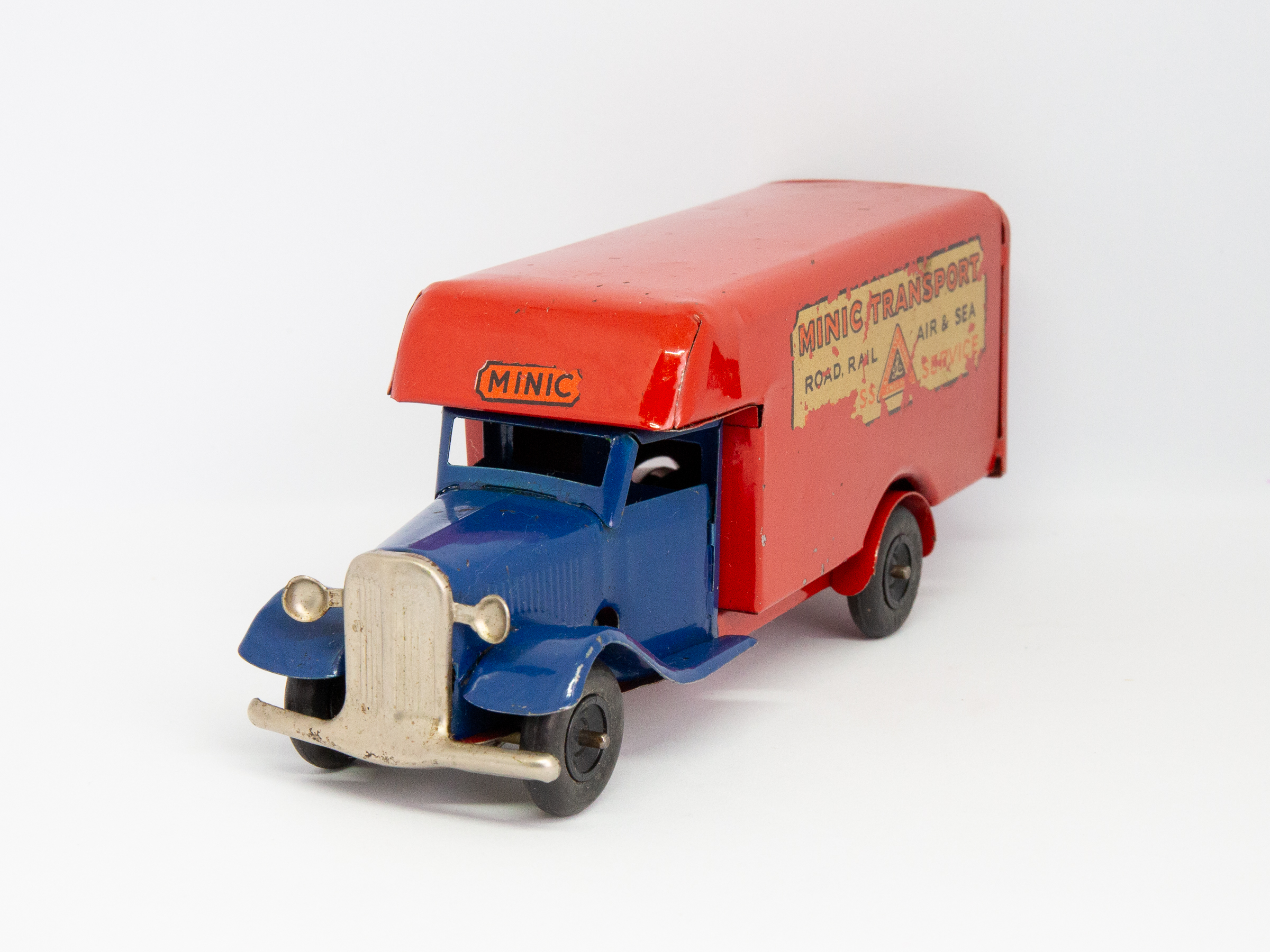 Vintage Minic clockwork delivery van. Wonderful Minic clockwork toy van including original key and box. Van measures approximately 150mm long by 46mm wide and 62mm tall. Main photo showing van only at a diagonal angle with van front in bottom left of photo.
