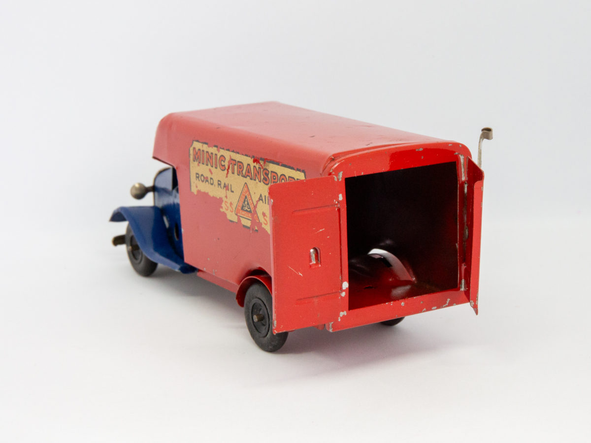Vintage Minic clockwork delivery van. Wonderful Minic clockwork toy van including original key and box. Van measures approximately 150mm long by 46mm wide and 62mm tall. Photo of back of van with doors open.