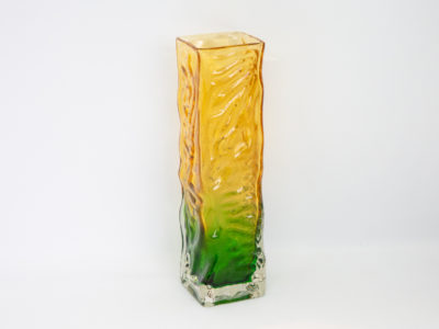 Whitefriars small rectangular vase. Small and sweet Whitefriars rectangular glass vase with a vibrant green base and yellow top. Measures 47mm square at base. Main photo showing vase from a near eye level angle with mostly one flat side showing.