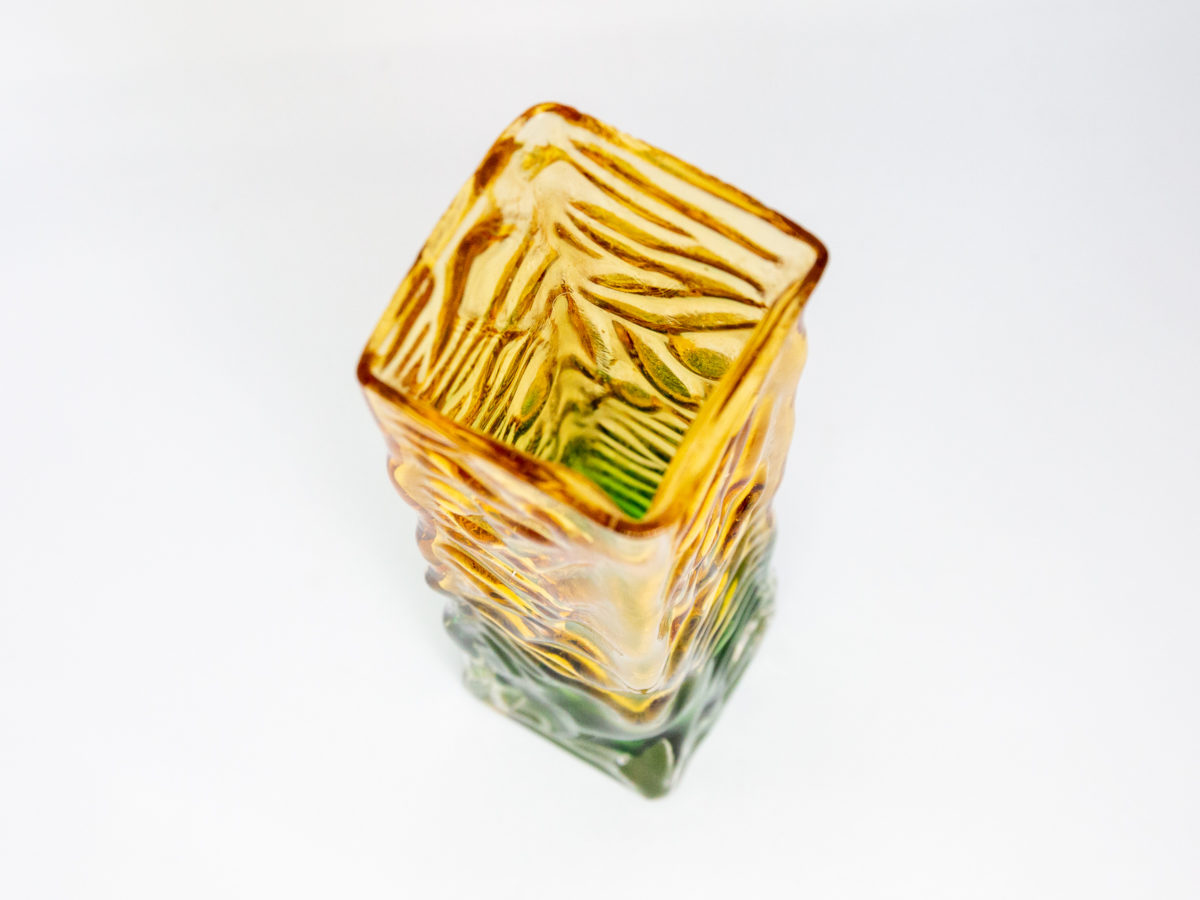 Whitefriars small rectangular vase. Small and sweet Whitefriars rectangular glass vase with a vibrant green base and yellow top. Measures 47mm square at base. Photo of vase looking down to the inside from above.