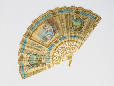 Vintage Continental hand-painted fan. Exquisitely detailed small hand-painted fan in cream and pale blue with a romantic lovers theme to the centre. Whole fan is accentuated with gold and silver sequins so you can sparkle as you fan! Measures approximately 190mm long and 25mm wide when closed and 345mm when open. Main photo showing an open fan with the fan base in the bottom right hand corner of photo.