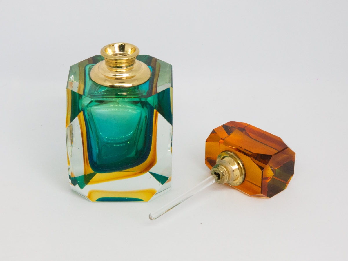 Mid century modern Murano glass perfume bottle. Small stunning Murano Sommerso perfume bottle in burnt amber, aqua and clear glass. Screw top stopper with brass neck and clear glass applicator. A really beautiful piece of modern glass art attributed to Flavio Poli. Photo of bottle with stopper removed and placed to the right of the bottle. The glass applicator rod is visible attached to the stopper.