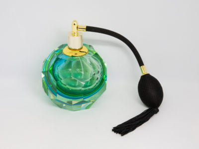 Mid century modern Murano glass perfume atomiser. A gorgeous hexagonal Murano Sommerso perfume atomiser bottle in aqua green and blue finished with a brass top and long black spray atomiser bulb. Attributed to Flavio Poli. Measures 55mm in diameter at base and 85mm in diameter at most bulbous central area. Main photo of bottle near to eye level with atomiser puff to the right.
