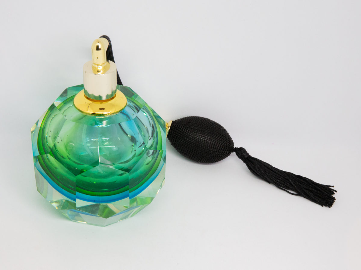 Mid century modern Murano glass perfume atomiser. A gorgeous hexagonal Murano Sommerso perfume atomiser bottle in aqua green and blue finished with a brass top and long black spray atomiser bulb. Attributed to Flavio Poli. Measures 55mm in diameter at base and 85mm in diameter at most bulbous central area. Photo of bottle shown with spray hole facing camera and atomiser puff behind