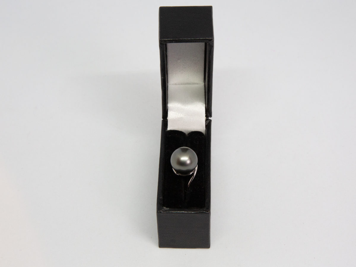 Modern Tahitian black pearl and white gold ring. Elegant and aesthetically pleasing ring in 18 karat white gold with large natural Tahitian black pearl. Comes with small ring box. Ring size N / 6.5 Ring weight 4gms. Photo of ring displayed in its ring box.