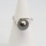 Modern Tahitian black pearl and white gold ring. Elegant and aesthetically pleasing ring in 18 karat white gold with large natural Tahitian black pearl. Comes with small ring box. Ring size N / 6.5 Ring weight 4gms. Main photo of ring displayed on a cone shaped stand and shown with pearl front face on.