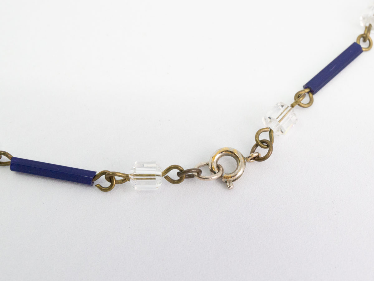 Vintage Art Deco crystal glass necklace. Subtly sparkly handmade clear and navy crystal bead necklace linked with brass throughout. c1930. Clasp not original. Close up photo of the brass clasp.