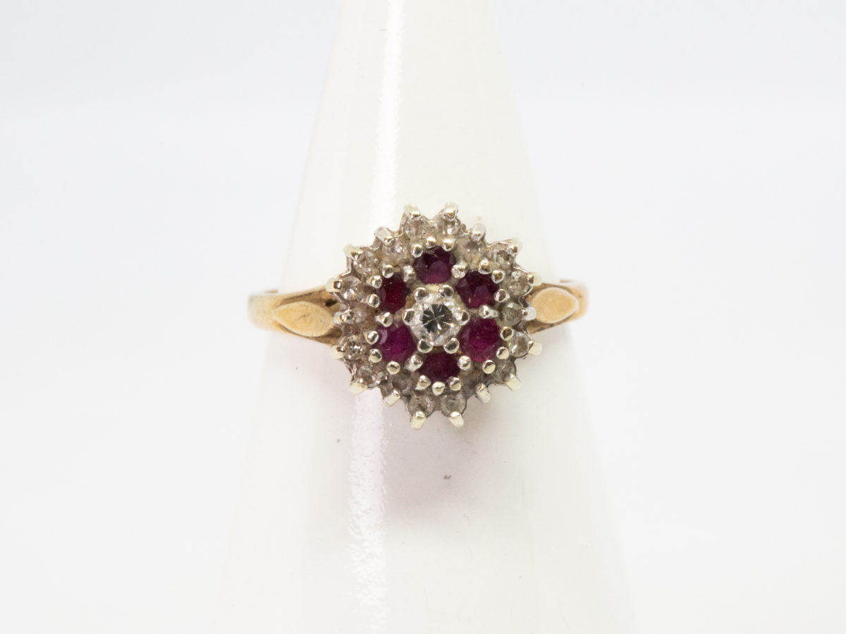 Vintage 9 karat gold ring. Pretty ring with a floral front of rubies and diamonds. Full hallmark to inside band for Birmingham assay c1987 Ring size L / 5.5 Main photo of ring displayed on a cone shaped stand and seen with ring front forward facing.