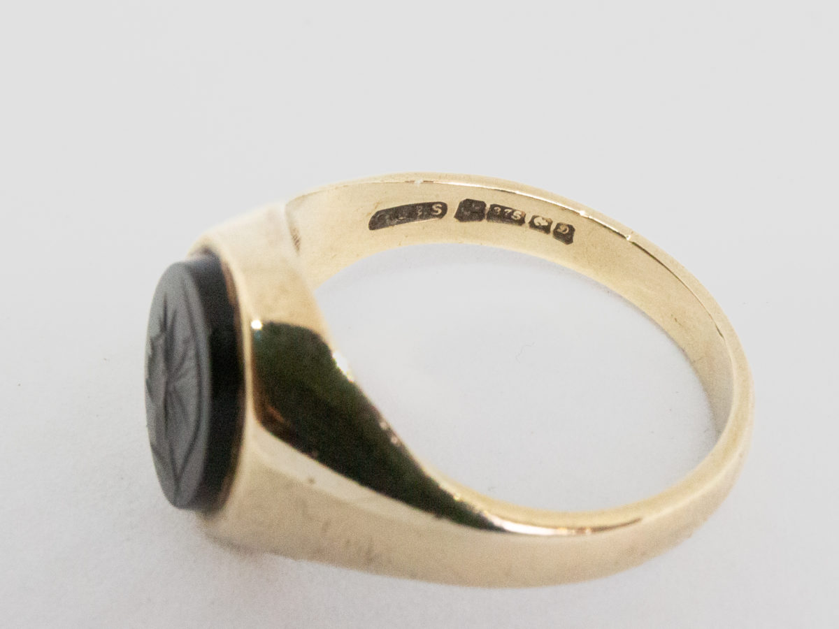 Vintage 9 karat gold and hematite ring. c1978 Birmingham assayed 9 karat gold ring set with a hematite intaglio showing profile of a Roman soldier. Ring size T.5 / 9.75 Close up photo of the full hallmark on the inside band.