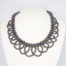 Modern black pearl necklace in a collar form. Intricately designed necklace with multiple iridescent black pearls and finished with a sterling silver clasp and slightly adjustable chain. Box included. Adjustable from approximately 400mm to 455mm. Necklace weight 57.6 grams. Main photo of necklace displayed on a stand and shown front facing.