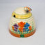 Clarice Cliff 'Autumn Crocus' honey pot. A sweet and classic Clarice Cliff design honey pot hand-painted in the Autumn Crocus pattern. Shaped in the form of a beehive with a bee handle to the lid. In excellent condition throughout with only minor stain on small inside area. Signed Clarice Cliff to the base. c Late 1930s. Base of pot measures 96mm in diameter. Height excluding bee handle 85mm. Main photo of pot with lid in place, bee handle to the right, spoon hole on lid to the left and green painted hive entrance at the bottom.