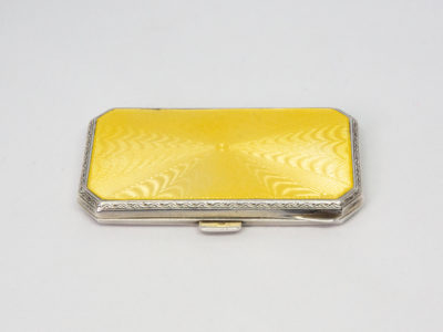 Ladies guilloche enamel and silver cheroot case. Stunning ladies Art Deco cheroot case with yellow guilloche enamel to one side. 925 hallmark for sterling silver in several areas. Gilded interior. In wonderful condition throughout and closes tight. Missing the elasticated band inside. Import mark for Glasgow c1925. Made by Scholl Ltd. Main photo of cheroot case laid lengthways on a flat surface with the yellow guilloche enamel side up or sunny side up!