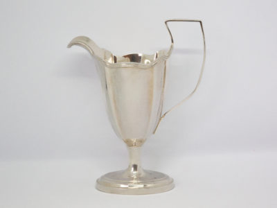 Antique sterling silver milk or cream jug. Aesthetically stunning jug by Thomas Bradbury of London c1904. Full hallmark to back of jug by handle. Base measures 63mm by 44mm, 110mm at widest from tip of spout to handle edge and 136mm at tallest at handle. Main photo showing jug from an eye level angle with spout to the left and handle to the right.