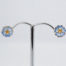 Vintage Sheila Fleet enamelled silver earrings. A sweet pair of sterling silver stud earrings in a flower shape with blue enamel to the petals by Sheila Fleet, Orkney Islands. Hallmarked 925 on stud post and butterfly. Original Sheila Fleet box included. Flowers measure approximately 8mm in diameter and weigh 1.7gms. Main photo of earrings displayed on a stand shown front facing.