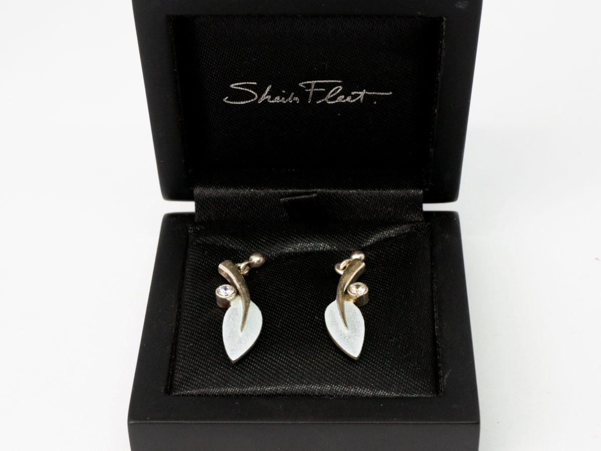 Vintage enamelled sterling silver leaf earrings. Beautiful pair of sterling silver and enamel dangle earrings in the form of a dangling leaf with a cubic zirconia accent to the side. Made by Sheila Fleet, Orkney Islands. Hallmarked 925 to back of earrings and butterflies. Comes in original Sheila Fleet box. Drop length approximately 30mm. Earrings weigh 4.4gm. Photo of earrings displayed inside original Sheila Fleet box.
