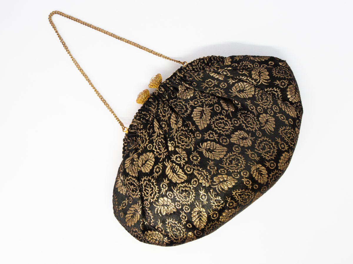 Vintage French black and gold evening bag. Small and pretty evening bag in black and gold with sparkly crystals to the clasp. Lovely cream satin interior with a small pocket housing a mirror. Some gilt wear to frame. Drop length from chain handle to bottom of bag is 235mm. Photo of other side of bag.