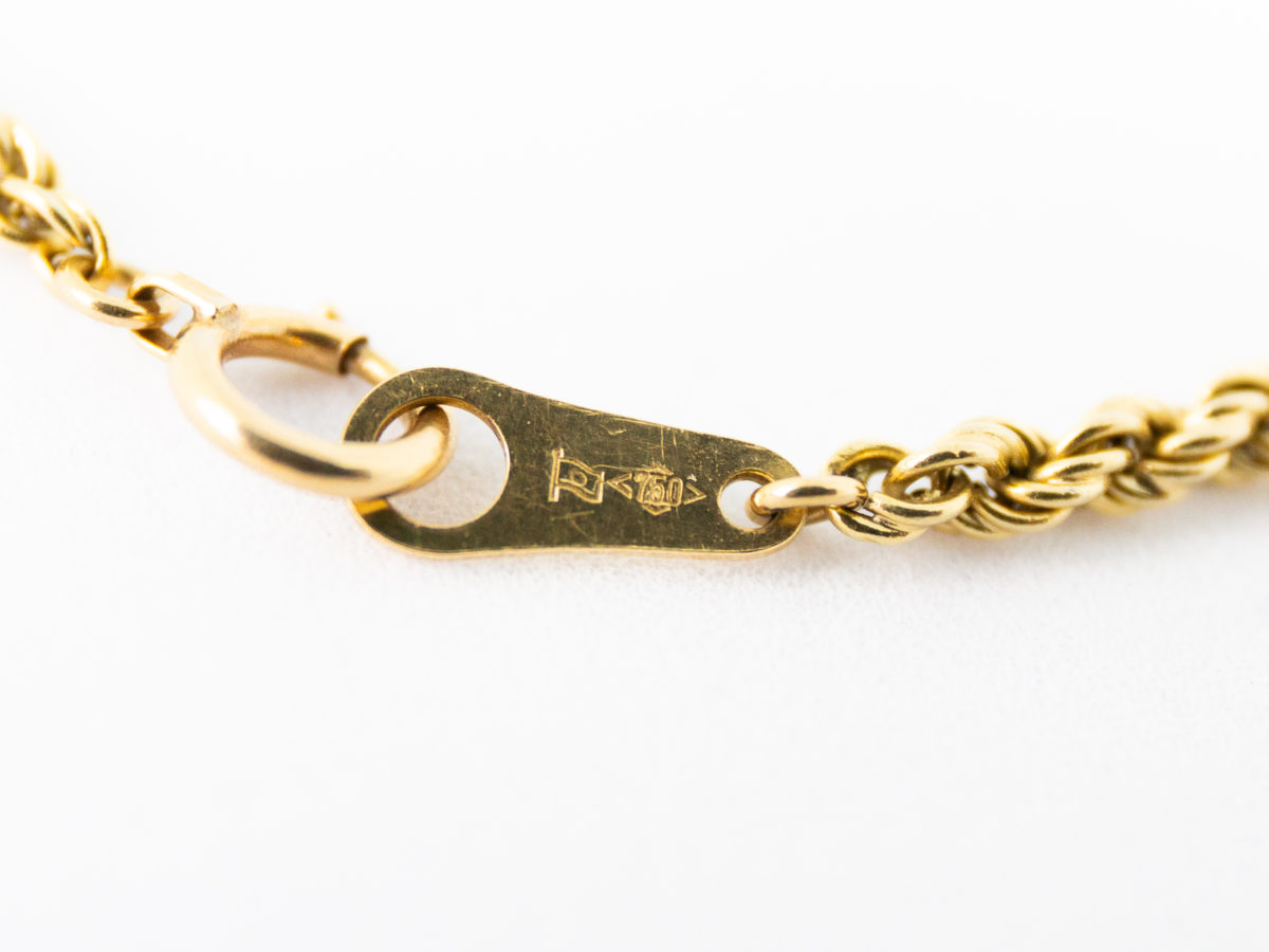 Vintage 18 karat gold rope chain bracelet. Fine rope chain bracelet in 18 karat yellow gold. Hallmarked 750 for 18 karat gold. Close up photo of the 750 hallmark on the clasp.