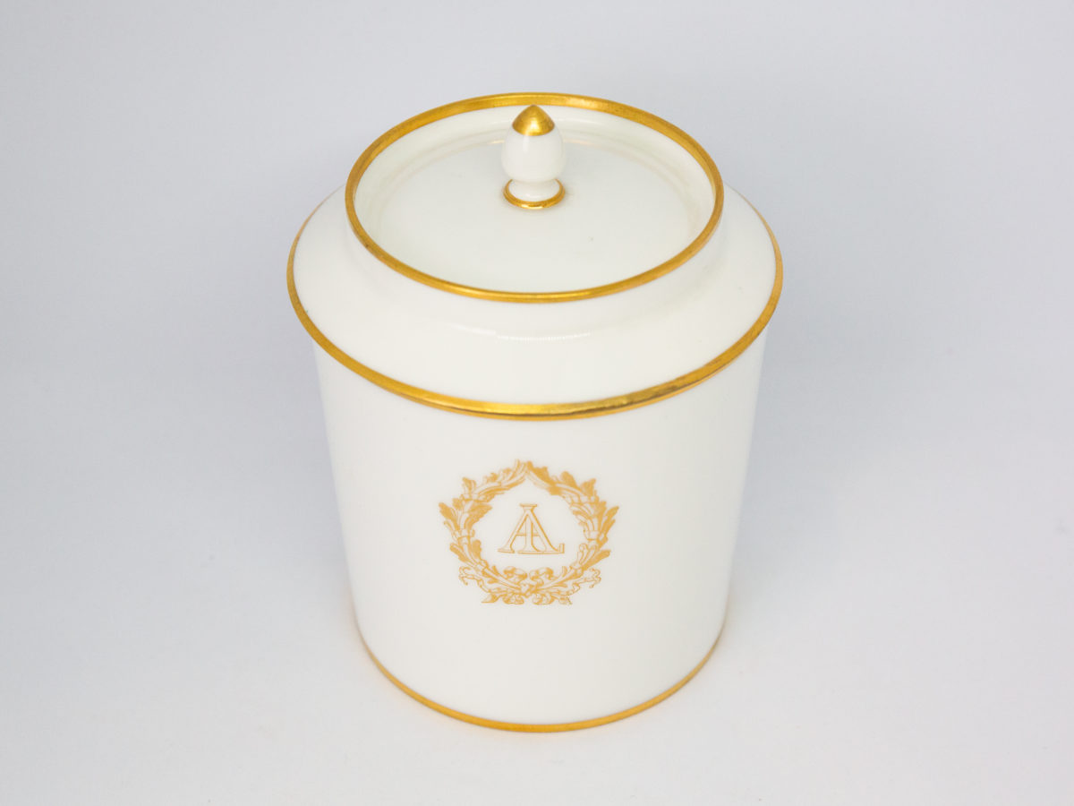 c1890 Dore a Sèvres lidded pot. Fine quality antique lidded pot in white porcelain with gilt accent. In excellent condition for its age. Stamped to base. Measures 85mm in diameter, top opening measures 95mm in diameter and lid overhangs at 102mm in diameter. Photo of pot with lid in place and seen from a slightly raised angle.