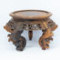 Vintage carved Chinese wooden stand. A nice sized Chinese stand in natural wood with lovely carved detail to the skirt under the stand and to the legs. Some repair work has been carried out as shown on photos. Outer diameter of top area measures 126mm and inner diameter measures 103mm. Widest area at top of legs measures 165mm. Main photo of stand shown from a near eye level angle.