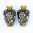 Pair of small mirror image cloisonné vases. Pretty and striking pair of cloisonné vases with mirror image of plum blossoms. The black background brings out the beautiful colour detail of the decoration. Measures 32mm in diameter at base and top and 60mm in diameter at widest area towards top of the vase. Main photo of the 2 vases displayed side by side and shown from the mirror image plum blossom side.