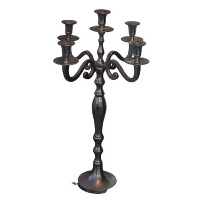 This silver metal 5 arm candelabra is a statement piece of table wear and would look stunning on a Christmas lunch table or for any special occasion meal. 610mm high each arm measures 150mm. COLLECT FROM STORE ONLY. Main photo showing the full height of candelabra with all 5 capitals visible.