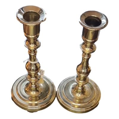 Pair of brass candlesticks made in America. The decorative pair measure 180mm high and 80mm at base. Main photo of both candlesticks upright and side by side looking slightly down into the capital.