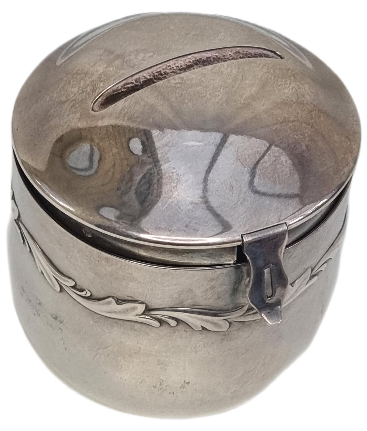 A delightful WMF money box circa 1910 in silverplate with a slot on top for inserting coins. The barrel shaped body has a decorative leaf pattern around its entirety. Main and only photo of the WMF barrel money box seen at a slight raised angle with coin slot visible at top
