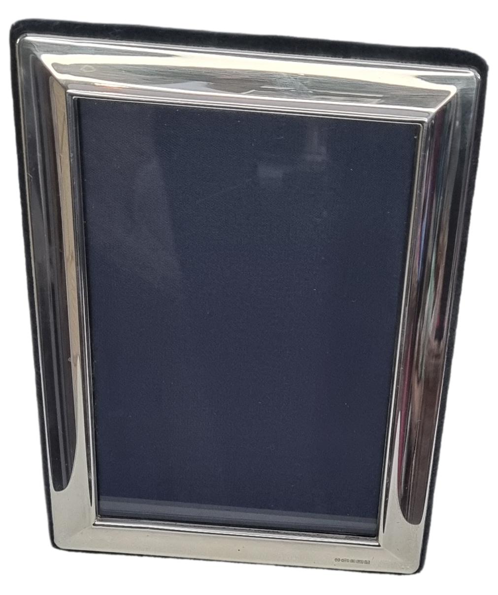 The silver photo frame is by Carrs and has a hallmark of Sheffield 2001. The frame has a blue velvet back with an easel stand. The frame is ready for use and would be an excellent gift idea for Christmas. Main photo of photo frame shown from the front.