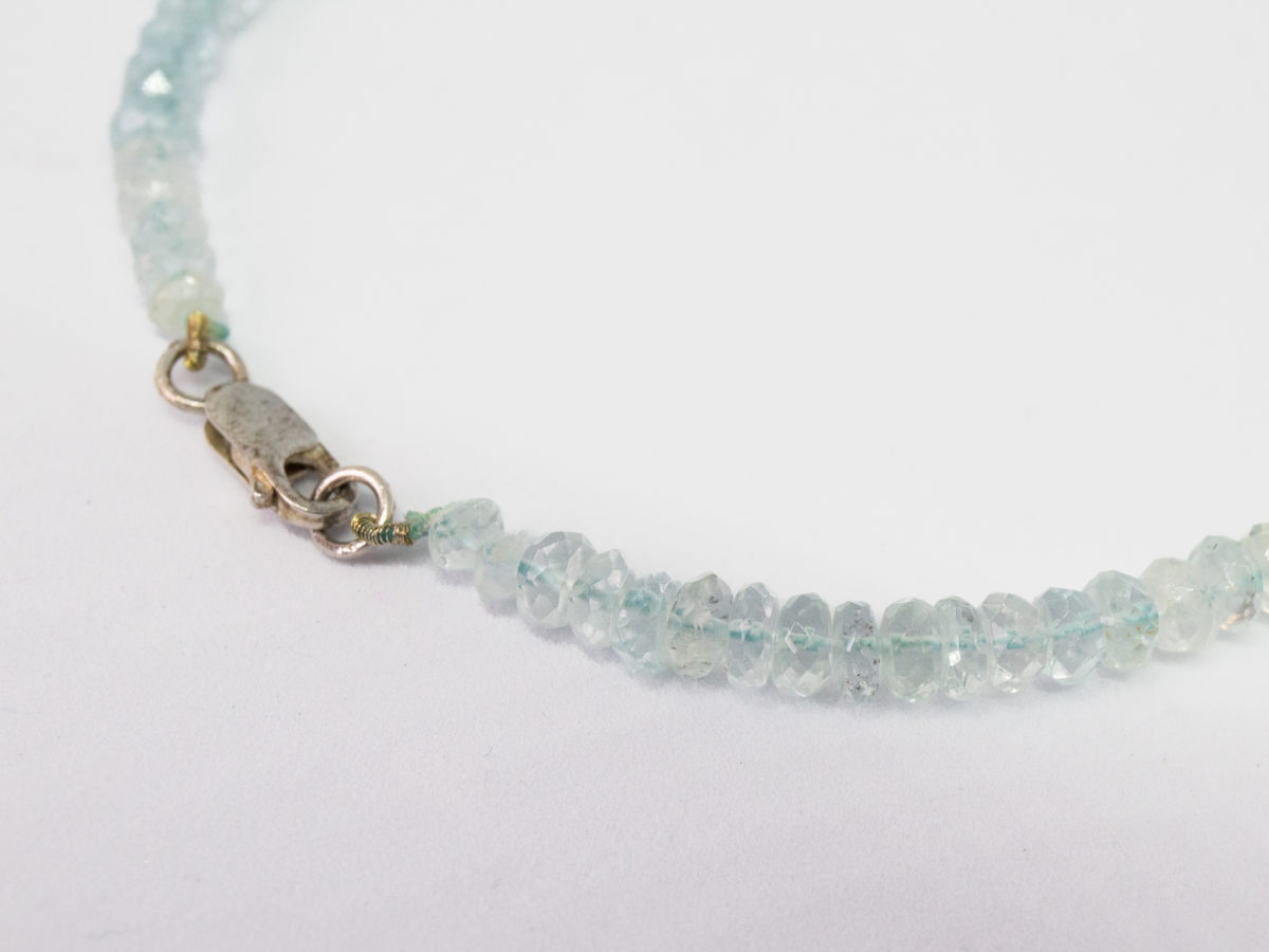 Modern aquamarine bead necklace. Pretty necklace made up entirely of graduating faceted aquamarine stones beautifully strung and finished with a sterling silver clasp. Close up photo of the clasp area.