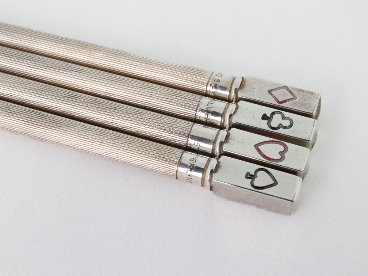 Set of sterling silver Bridge pencils. Lovely boxed set of 4 sterling silver propelling pencils with a card suit on the end of each pencil. All 4 pencils are hallmarked Sterling Silver with each one measuring 85mm and weighing approximately 6.5gms. Photo of the suited ends of all 4 pencils laid side by side