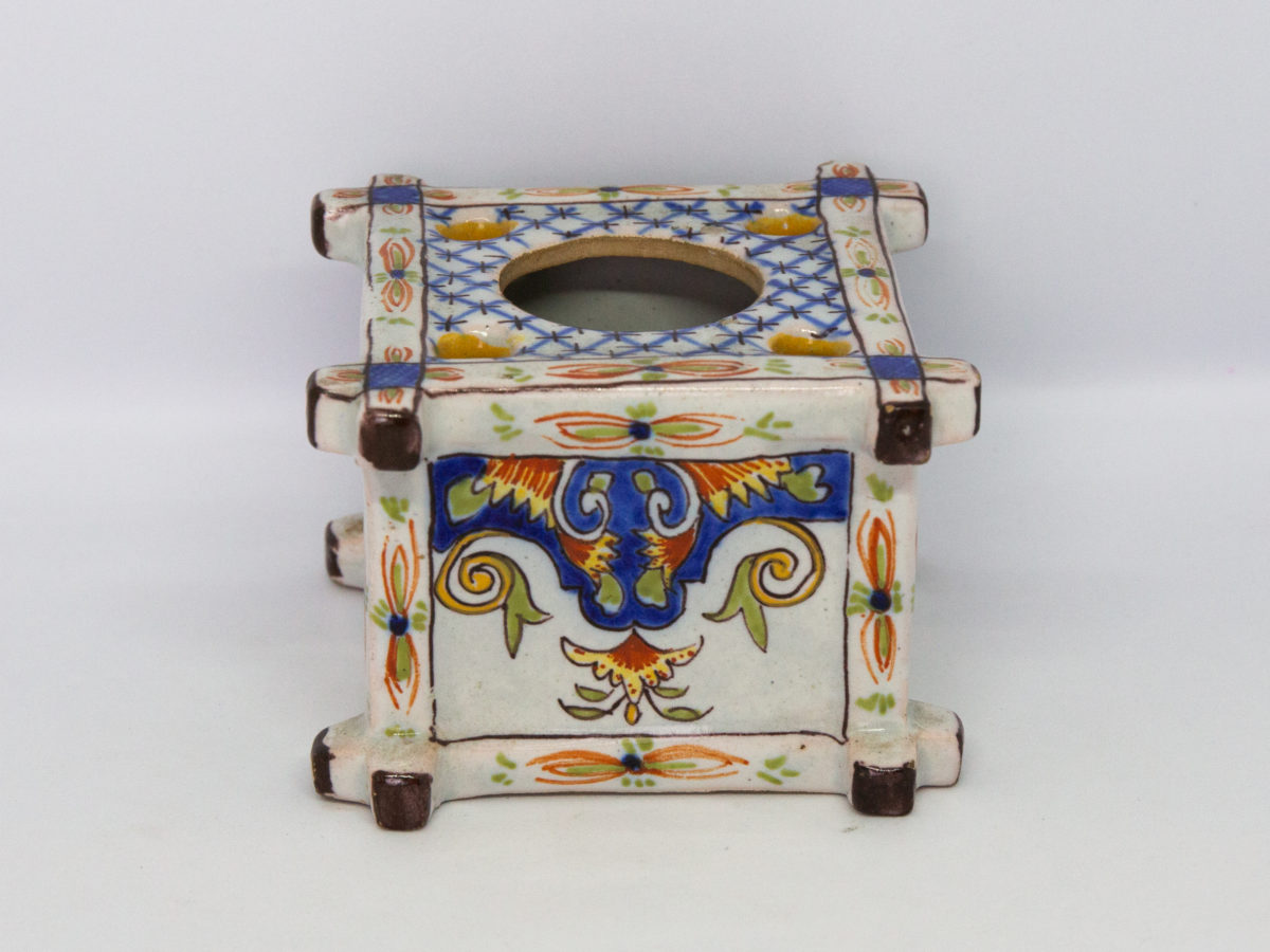 Late 19th century Faience inkwell. Antique inkwell attributed to Quimper and dated 1879 to the base. Beautifully hand painted in typical Quimper pottery colours with Brittany coat of arms and woman in traditional Breton costume. A couple of chips to the corners but otherwise in excellent condition for its age. Other side of brightly coloured decoration.