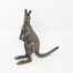 Antique Stewart Dawson kangaroo ornament. A small heavy kangaroo in standing position by Stewart Dawson. Assumed solid silver plate although no visible hallmarks whatsoever. Signed Stewart Dawson to the base of tail. c1900s Measures 85mm at longest from tip of foot to tail, 28mm at widest across hips and 98mm at tallest from ground to tip of ear. Main photo of kangaroo posed slightly off to the side with tail pointing top right and kangaroo facing bottom right of photo.