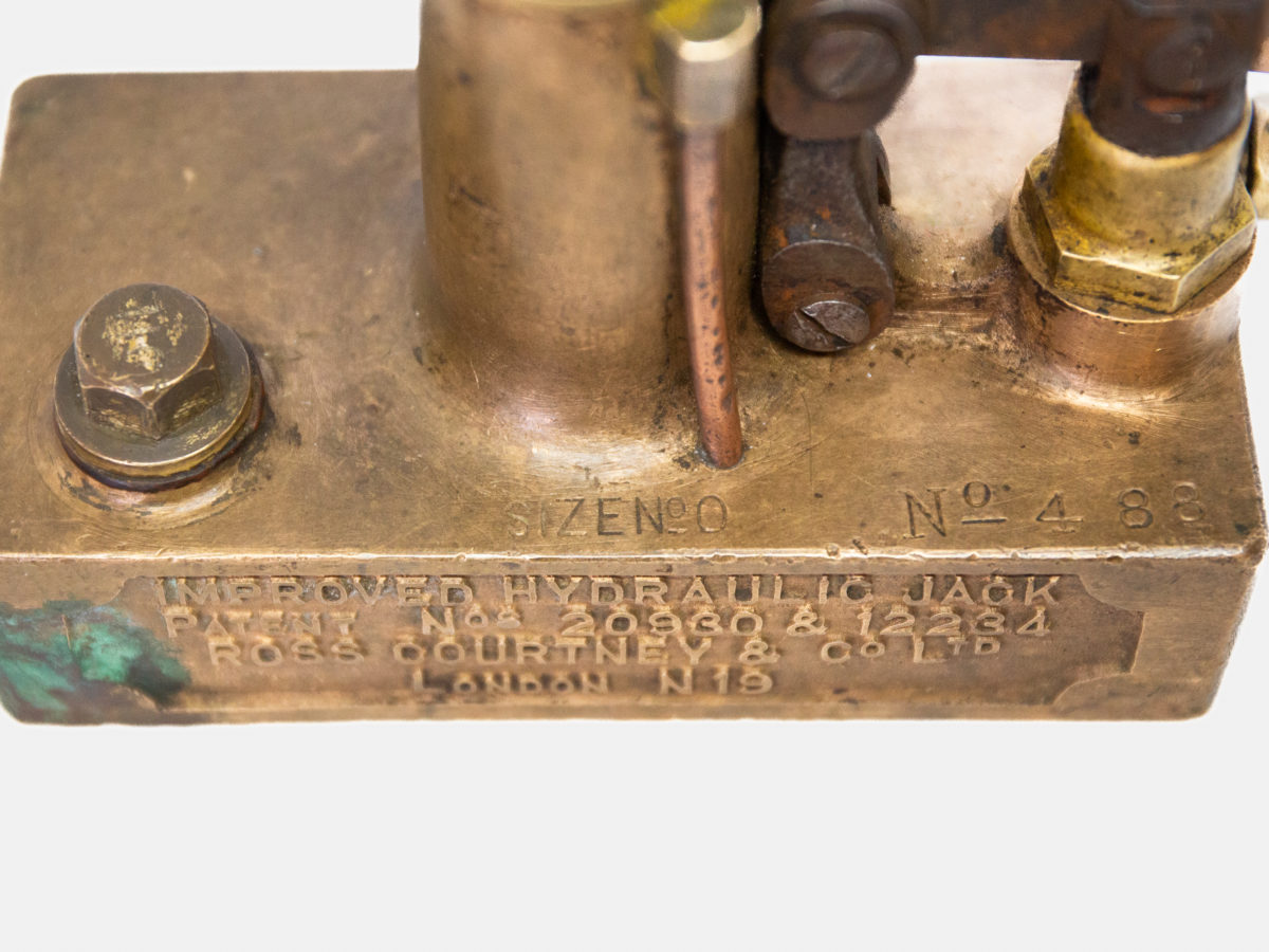 Rare antique hydraulic jack in copper, brass and iron. A very rare & heavy hydraulic jack patented 100 years ago in 1923. In working order albeit a bit erratic. These were made as an expensive optional extra for Rolls Royce or Bentley of the period. Patent No's and manufacturers info to the side. A lovely item and definitely a talking point! Base measures 152mm long by 75mm wide at base and 145mm at longest across the lever. Close up photo of the makers details and patent numbers on one side of the jack to the base.
