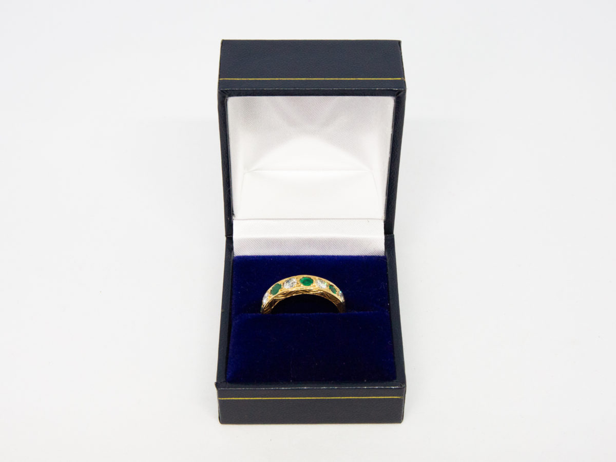 Vintage 18 karat gold ring with emeralds and diamonds. A stunning 18 karat gold ring set with 4 emeralds and 5 diamonds in an alternating row. Fully hallmarked for Sheffield assay c1975. Box included. Ring size O.5 / 7.25. Ring weight 3.8gms. Photo of ring displayed in a ring box.