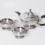 Antique Art Deco sterling silver tea set trio. A handsome sterling silver trio consisting of tea pot, sugar bowl and milk jug all in a very aesthetic Art Deco shape. Each piece is stamped to the base for Goldsmiths and Silversmiths Company 112 Regent Street and also fully hallmarked for Sheffield assay. The tea pot is dated for 1918, weighs 723.4gms and measures 102mm in diameter at base, 160mm in diameter at widest at top of body, 175mm wide from tip of spout to handle and 145mm tall at finial. There is also a etched picture of a thistle with motto 'Dulcius ex Asperis' (Sweeter after difficulties). The sugar bowl is dated for 1917, weighs 266gms and measures 70mm in diameter at base, 125mm in diameter at widest at top, 160mm at widest across handles, 60mm tall at main body and 65mm tall at handles. The jug is also dated for 1917, weighs 183gms and measures 64mm in diameter at base, 105mm in diameter at top, 145mm at widest from tip of spout to handle, 52mm tall at body and 65mm at tallest by handle. Main photo of all three pieces displayed together on a plain flat surface with teapot to the top right, sugar bowl to mid left and jug to centre front.
