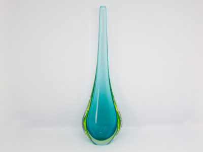 Vintage turquoise glass vase by Murano. Striking slender sommerso glass vase by Murano in stunning turquoise with vibrant sea green to the lower sides. The aesthetically stunning shape is akin to a drop of water and is very pleasing to the eye. A wonderful vintage glass art attributed to Flavio Poli. c1960s. Base measures 42mm by 30mm, the bulbous lower are measures 90mm wide by 60mm deep and top measures 12mm in diameter. The opening at top is very small measuring approximately 6mm in diameter. Main photo of vase with widest and flattest side shown and vibrant green to lowers sides visible.