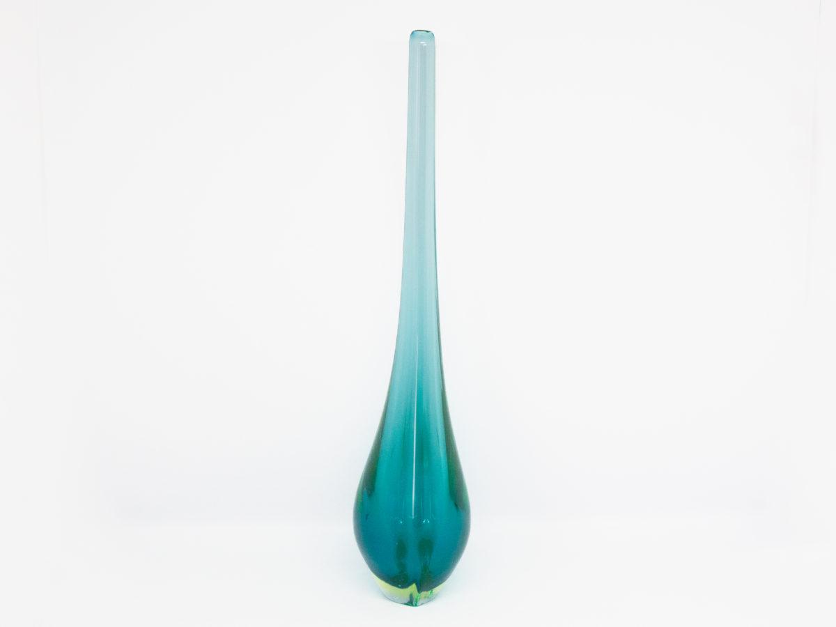 Vintage turquoise glass vase by Murano. Striking slender sommerso glass vase by Murano in stunning turquoise with vibrant sea green to the lower sides. The aesthetically stunning shape is akin to a drop of water and is very pleasing to the eye. A wonderful vintage glass art attributed to Flavio Poli. c1960s. Base measures 42mm by 30mm, the bulbous lower are measures 90mm wide by 60mm deep and top measures 12mm in diameter. The opening at top is very small measuring approximately 6mm in diameter. Photo of vase seen sideways on showing very little of the green.
