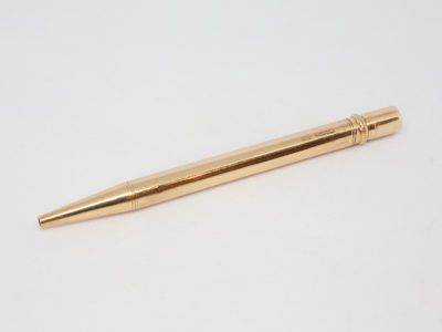 Vintage 9 karat gold propelling pencil. Very fine quality 9 karat gold pointer propelling pencil in excellent condition and working order. Fully hallmark for Birmingham assay c1975 and made by E. Baker & Son. Main photo showing pencil laid on a flat surface with lead end in the left of photo.