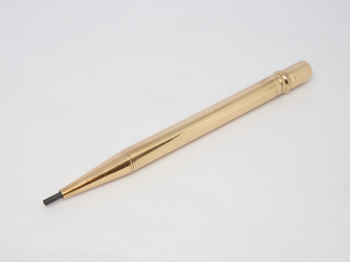 Vintage 9 karat gold propelling pencil. Very fine quality 9 karat gold pointer propelling pencil in excellent condition and working order. Fully hallmark for Birmingham assay c1975 and made by E. Baker & Son. Photo of pencil with lead of pencil protruding from tip.