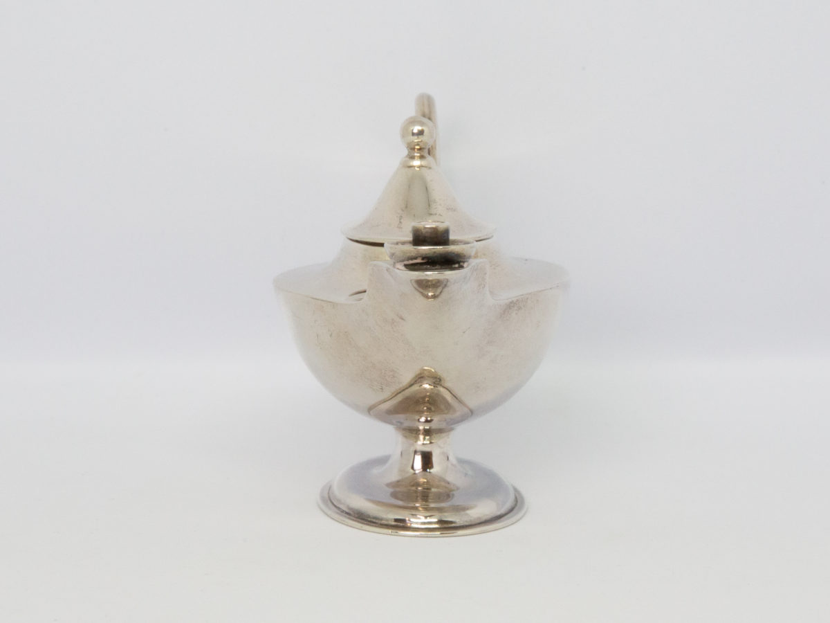 Antique sterling silver table light. Beautifully crafted small sterling silver oil light in the form of Aladdin's lamp. Fully hallmarked to the base for Sheffield assay c1913 and made by Roberts & Belk. (Extra hallmark stamp on this piece-very special!) Measures 52mm by 37mm at base, 112mm at longest from handle to tip of spout, 55mm at widest, 68mm tall at finial and 70mm at tallest. Photo of light with wick spout end to the centre foreground.