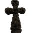Vintage vulcanite cross carved from one piece of vulcanite. Intricately decorated with roses in a 3d effect. Main photo of the cross seen from the front.