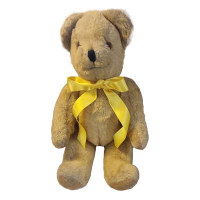The Canterbury teddy bear is from the 1980s and features a plush material button eyes and jointed body. He measures 360mm length x 180mm in width. COLLECT FROM SHOP ONLY. Main photo of teddy bear in a seated position and looking straight at camera - Cheese !!
