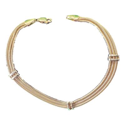 A vintage 9ct yellow and white gold bracelet. The bars which transverse the yellow gold ropes in white gold. It is fully hallmarked for 9ct gold. It weighs 6.3 grams. Each yellow gold rope is just over 1mm wide. Main photo of bracelet set out in a near circle with clasp undone.