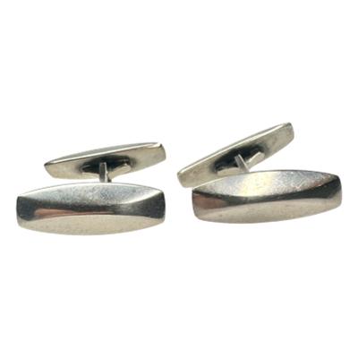 Pair of vintage George Jenson 925 silver cufflinks designed by Fleming Eskilden. Main photo of cufflinks on a flat surface and shown with wider main end in the foreground.