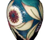Moorcroft vase in the Albany pattern is highly decorative full of colour and interest produced in the year 2000 by Nicola Slaney. Main photo of vase seen from an eye lvel angle showing the Albany decoration to the side.