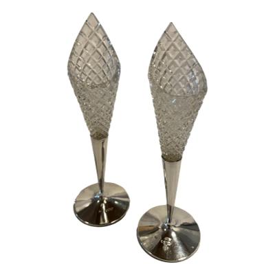 Antique pair of sterling silver and cut glass lily shaped vases. Full hallmark for London assay c1900 and made by W. M. Comyns. Each vase measures approximately 60mm in diameter at base and 150mm tall at low glass end and 185mm at tallest. Main photo of both vases shown side by side with one slight back from the other.
