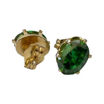 14 karat gold stud earrings set with half a carat of oval cut chrome diopside to each. Hallmark to the earring posts. Each stone measures approximately 6mm x 4.5mm. Photo showing one earring facing forward and back of other.
